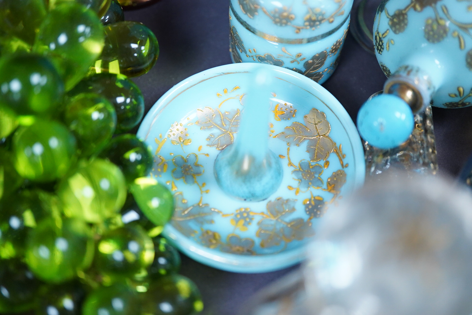 A collection of 19th century and later glassware to include gilt scent bottles, fruit ornaments and beakers, largest 14cm high